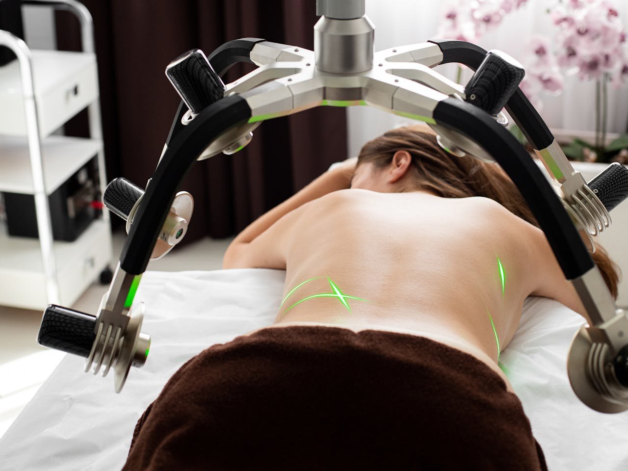 services-03 A woman undergoing a contemporary laser fat reduction treatment in a clinic.