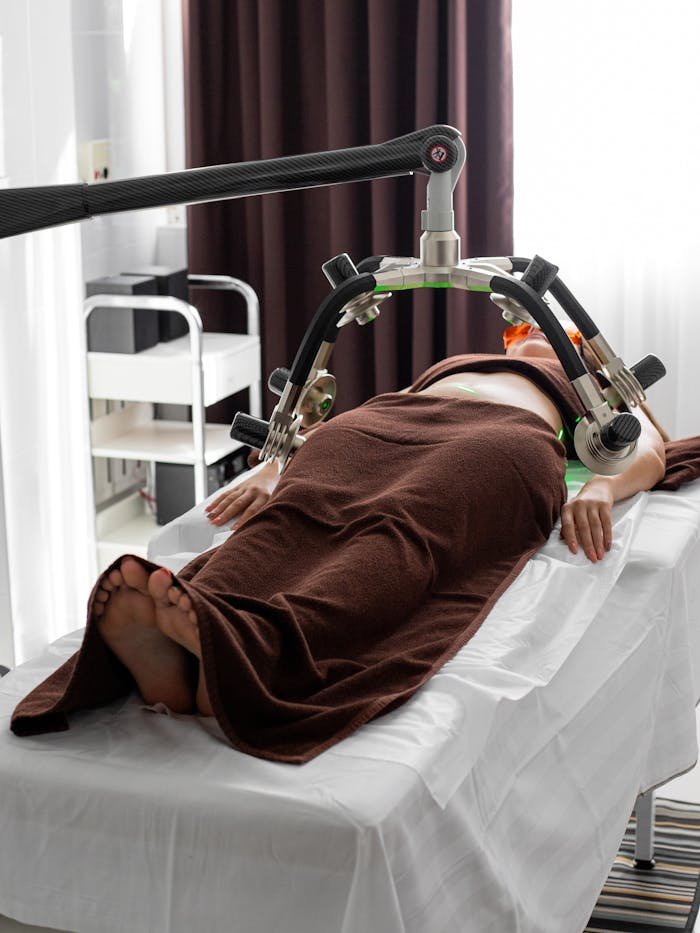 about-us Female patient undergoing a contemporary laser treatment for weight loss in a medical clinic.